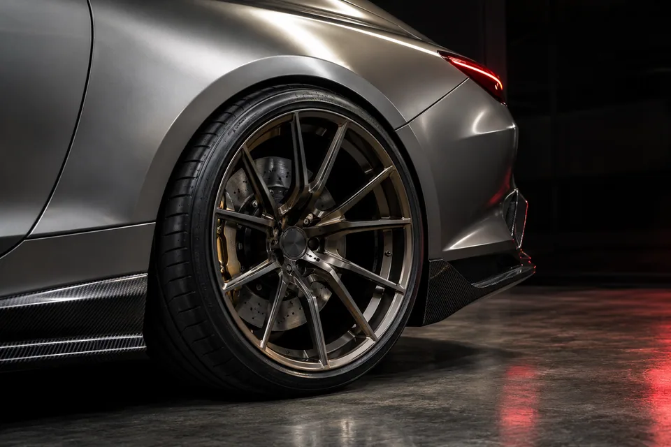 Detailed graphite wheel, sculpted silver arch and carbon side skirt, generated concept